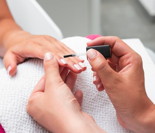 high-angle-woman-doing-manicure-client high-angle-woman-doing-manicure-client